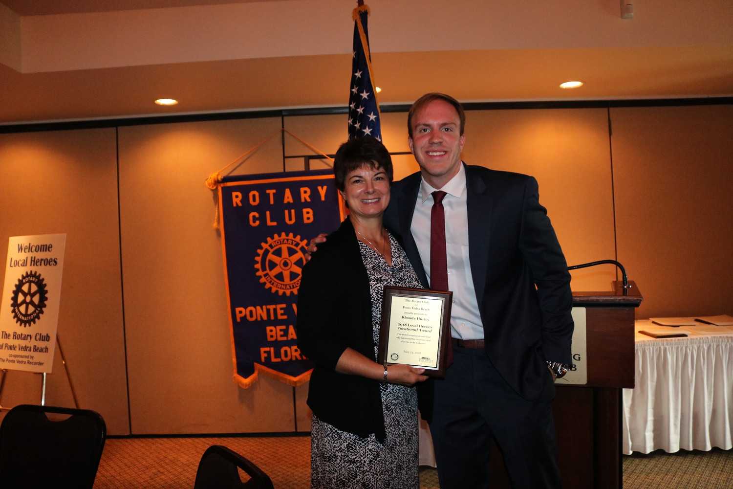On behalf of Rhonda Hurley, Rotarian and Mission House Executive Director Lori Anderson receives the Vocational Service Award from Ponte Vedra Recorder Editor Jon Blauvelt.